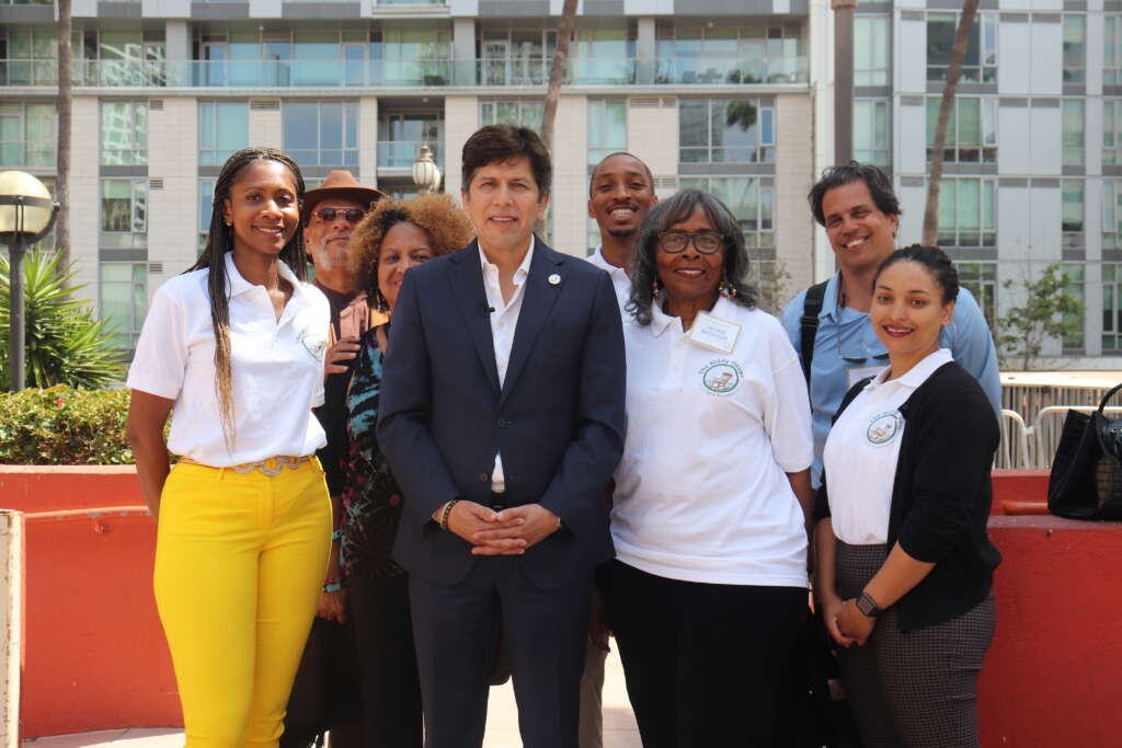 Former Councilmember Kevin de León surrounded by BMCF staff and volunteers, standing in Pershing Square, now Biddy Mason Park